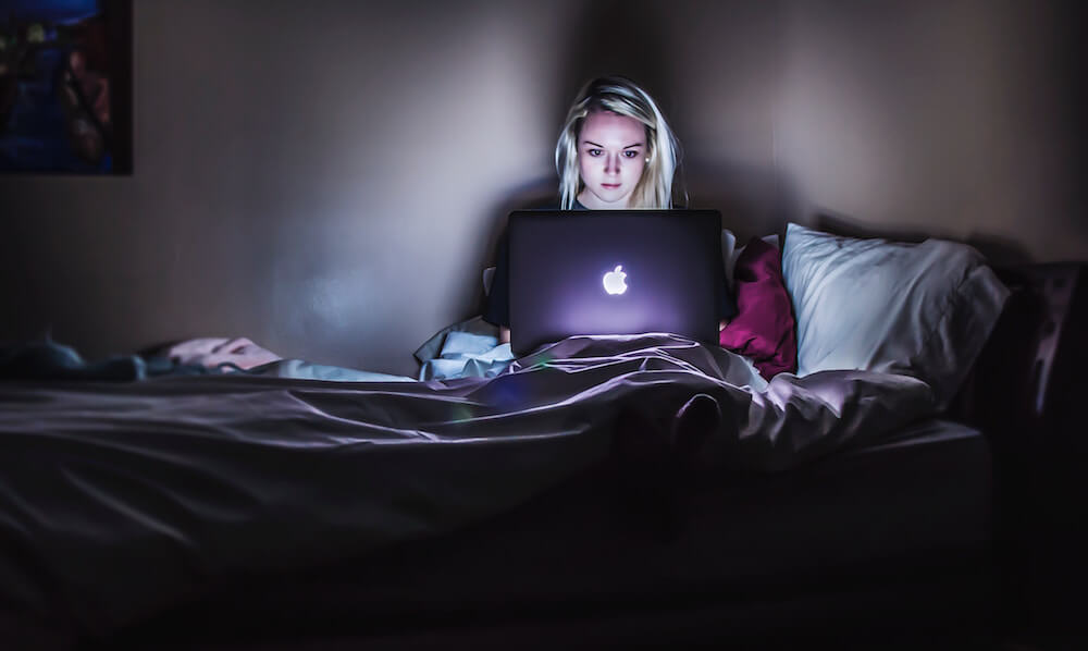 Woman hustling on laptop at night